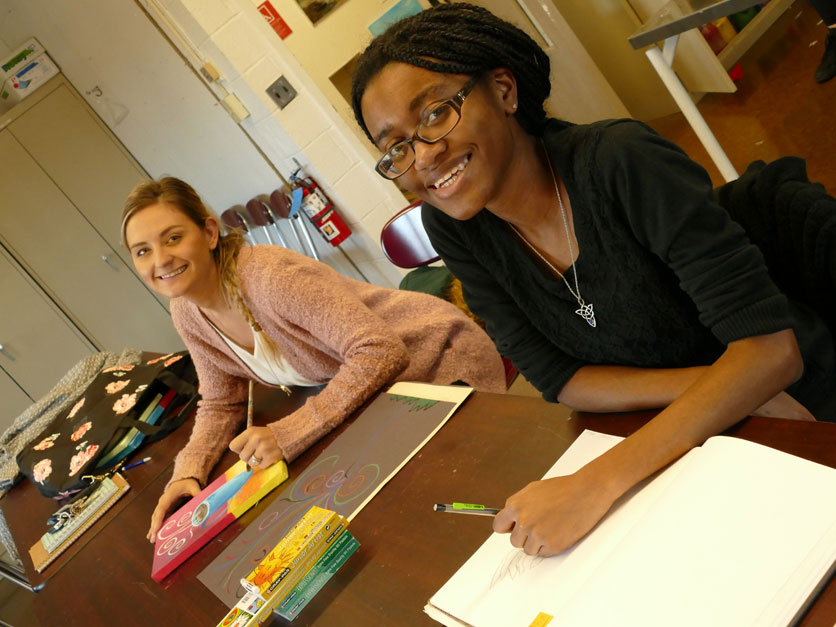 Two art students working