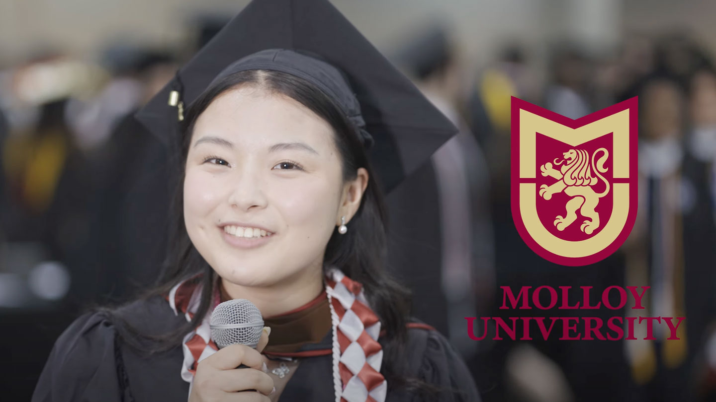 Molloy University graduate, Ruri Kodama speaking in a microphone about her experience at Molloy and in the CAP21 program