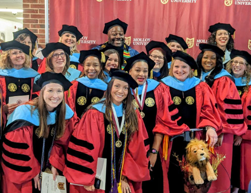 Doctoral Molloy University Graduates gathering for a photo