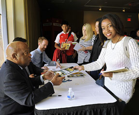 A member of the class of 2019 has her book, March, signed by Congressman John Lewis.
