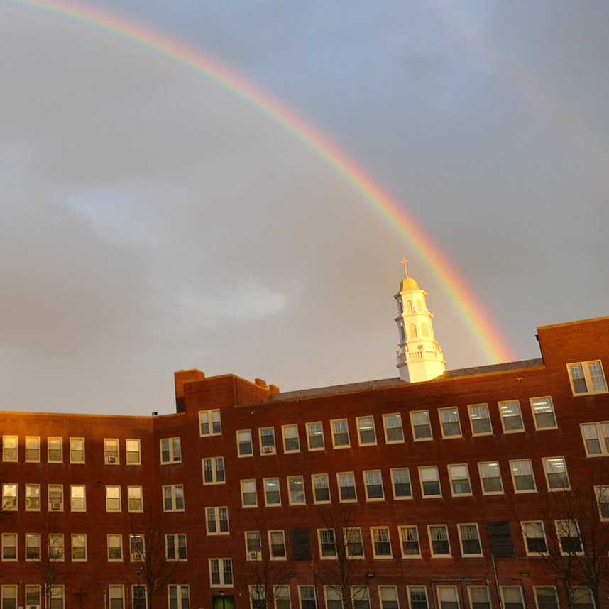 Rainbow over a building on the Molloy University campus