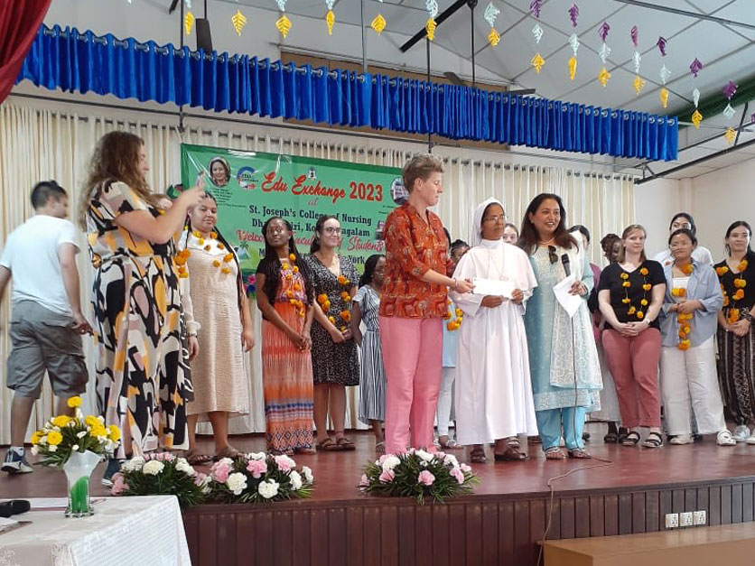 People on a stage receiving awards in an international cultural exchange ceremony