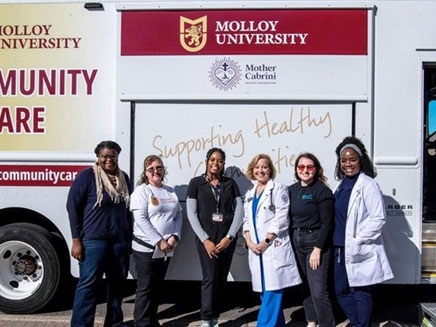 The mobile clinic with some of the providers and teachers