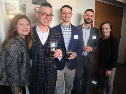 Dawn DiStefano, associate dean of Molloy University and director of undergraduate programs at the school of business, joins Molloy alumni Mike Russo and other school of business graduates for the 10-year anniversary of the Capstone program.