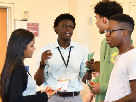 Group of Molloy University students talking