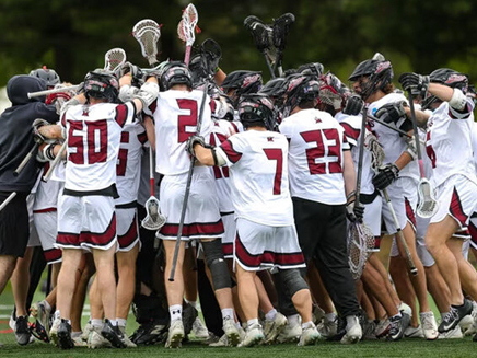 Molloy's mens lacrosse team huddled up, celebrating their victory 