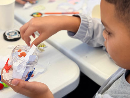 Freeport student on learning bus with gratitude jar