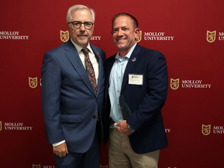 Christopher Panetta, M.S. ’19 posed with President of Molloy University Jim Lentini