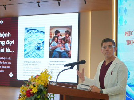 Patro speaking at conference