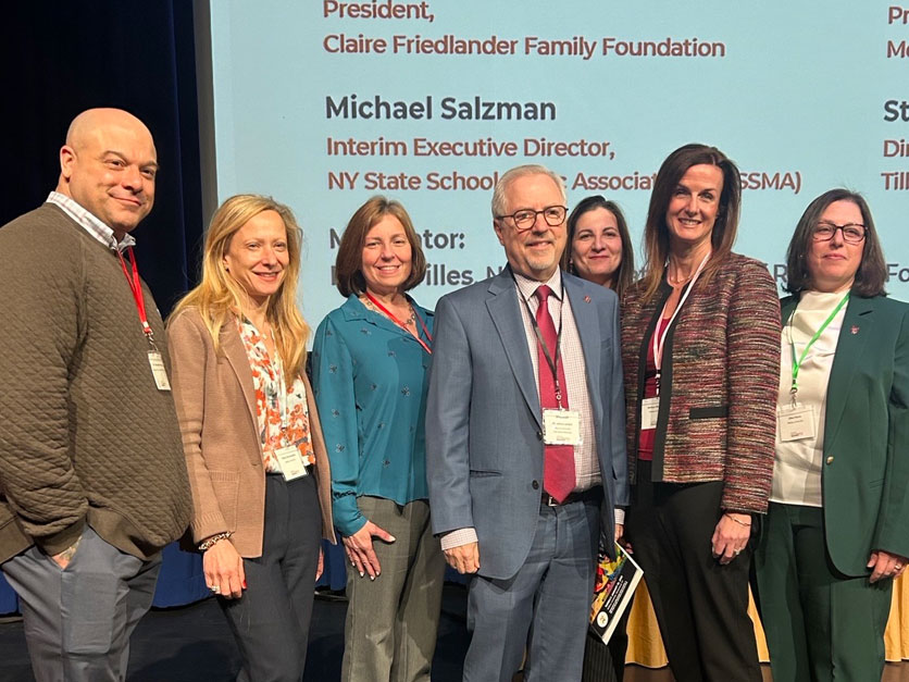 Molloy President James Lentini, professors and staff on stage