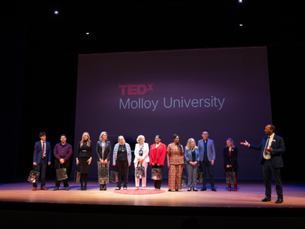 Dean Porter on stage with TedX speakers