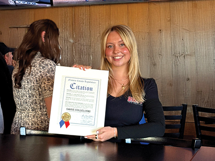 Photo of student Sage holding up certificate for saving a life 