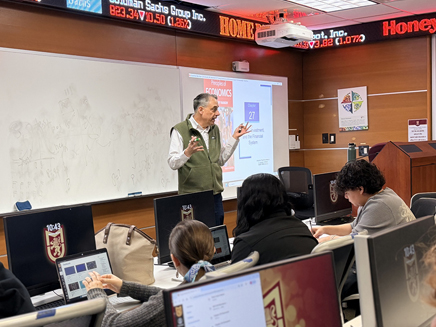 Steven Kent teaching in Molloy University trading room 