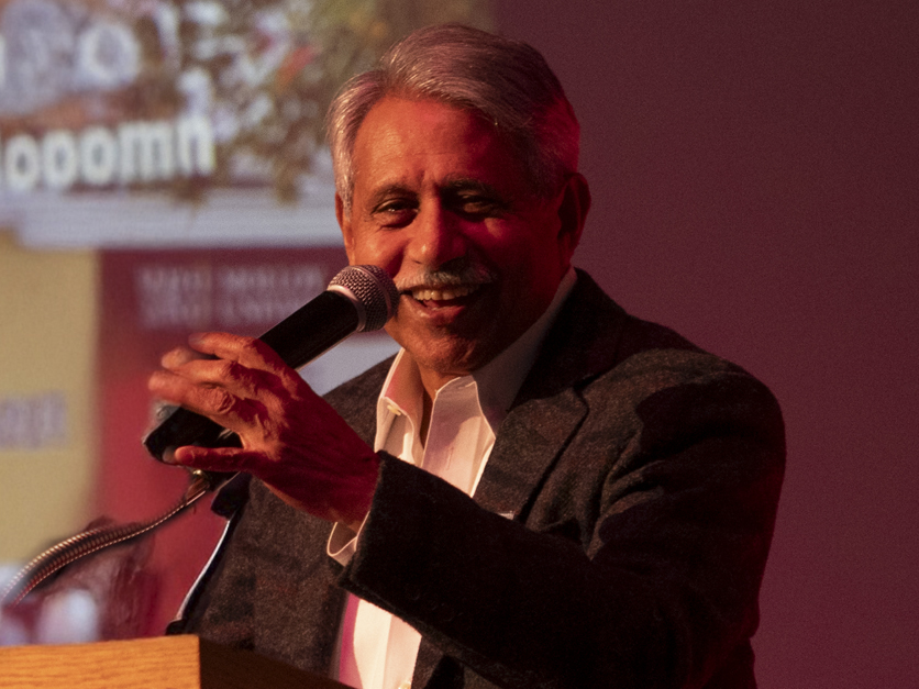 Zaki Hossain with microphone at Legacy for Learning dinner.