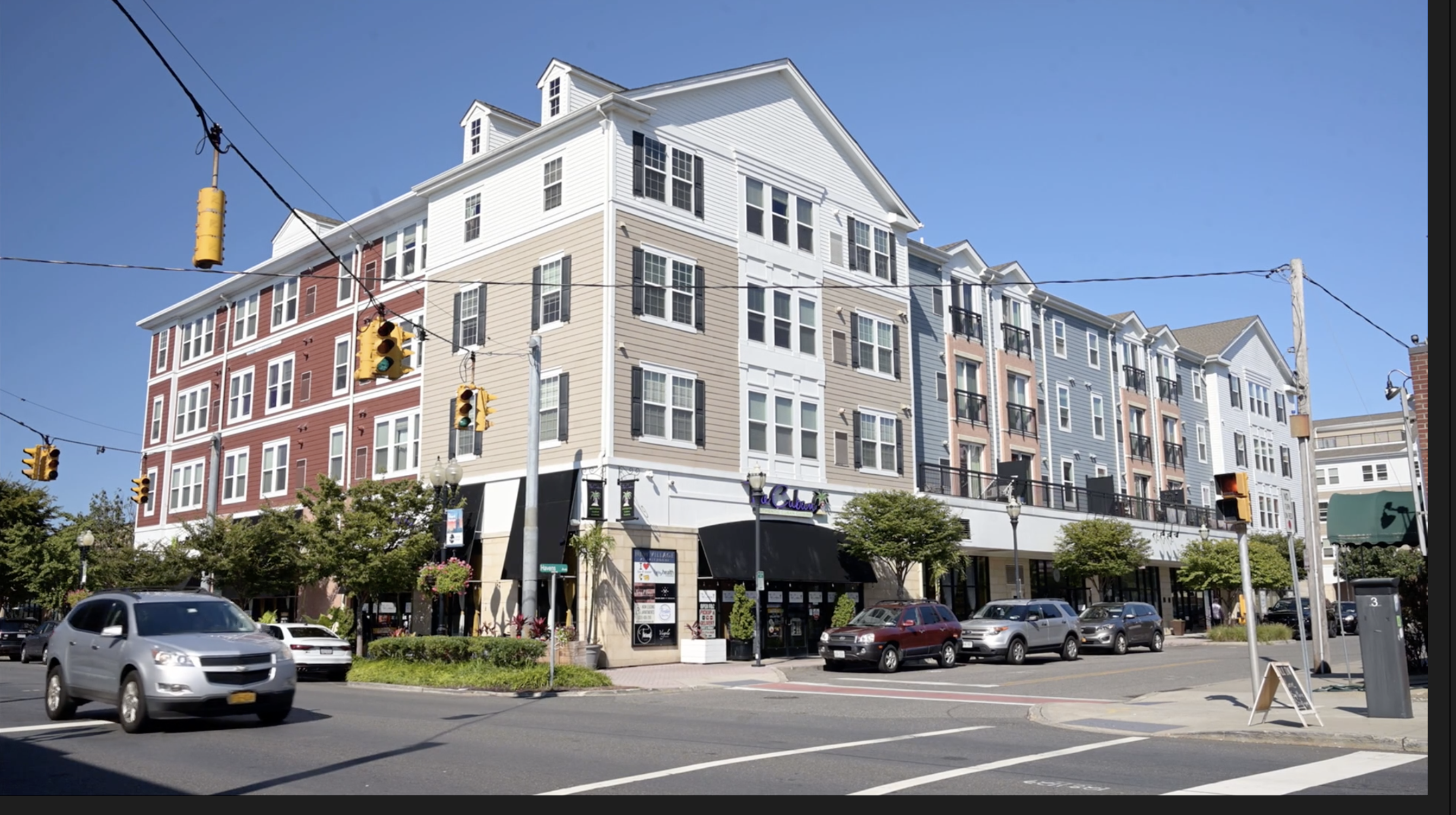 Photo of a mixed-use building with retail on the first floor and apartments above