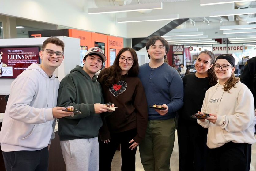 students smiling at registration fest in public square lobby