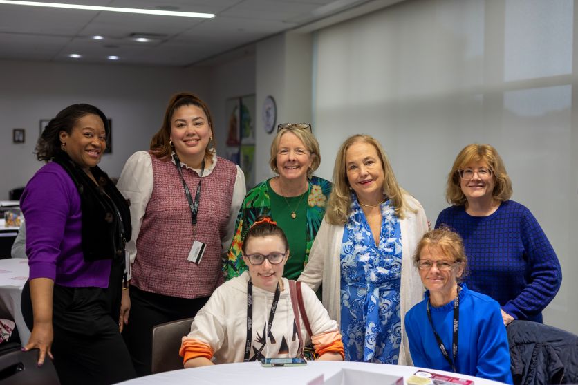 A student sitting with Molloy faculty and administrators.