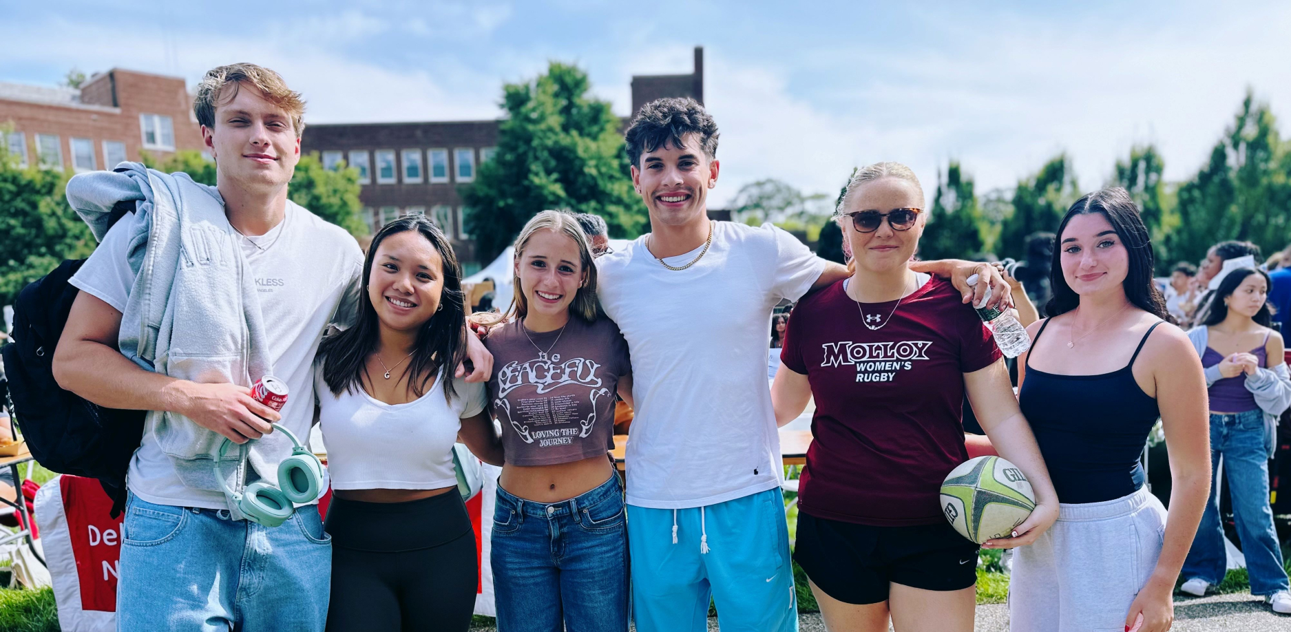 Molloy University students smiling in front of Public Square