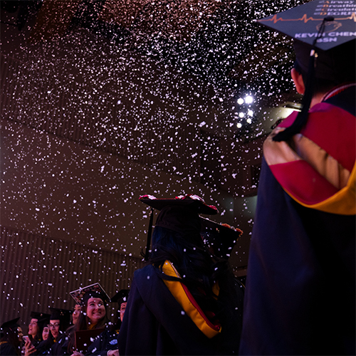 Graduates during Winter Commencement indoor snow