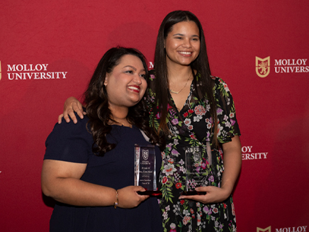 Two Molloy Allumni on campus receiving awards